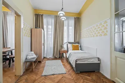 a bedroom with a bed and a desk and a table at Charles Bridge Historical APTs by Michal&Friends in Prague