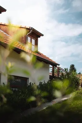 a house with the sun shining on the roof at Pod Vojtěchem - soukromý wellness apartmán in Wotitz