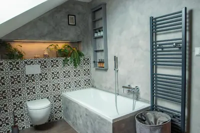 a bathroom with a bath tub and a toilet at Pod Vojtěchem - soukromý wellness apartmán in Wotitz