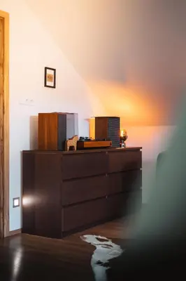 a wooden dresser in a room with a staircase at Pod Vojtěchem - soukromý wellness apartmán in Wotitz