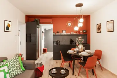 a living room with a table and a kitchen at Chill in Oriental Splendour in Prague