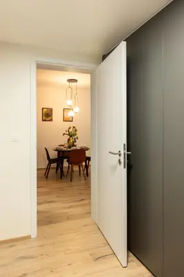 an open door leading into a dining room with a table at Chill in Oriental Splendour in Prague