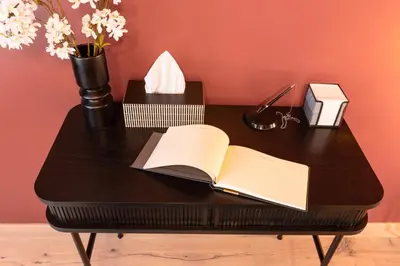 an open book on a black table with flowers at Chill in Oriental Splendour in Prague