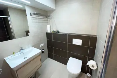 a bathroom with a white toilet and a sink at Residence My Mozart in Prague