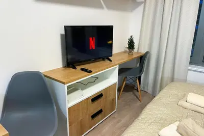 a room with a tv on a desk with a chair at Residence My Mozart in Prague
