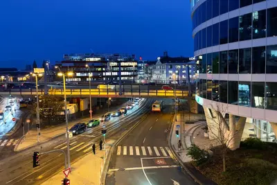 a city street with cars on the road at night at Rezidence My Mozart in Prague