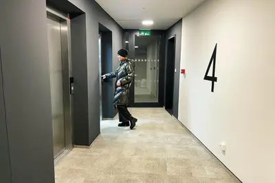 a woman walking down a hallway in an elevator at Rezidence My Mozart in Prague