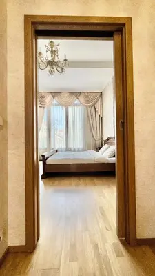 a bedroom with a bed and a large window at Stylish riverside apartment in Prague