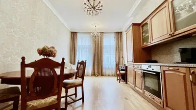 a kitchen with a table and a dining room at Stylish riverside apartment in Prague