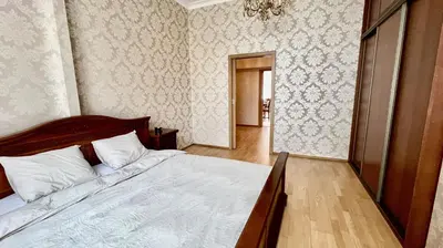 a bedroom with a bed and a hallway at Stylish riverside apartment in Prague