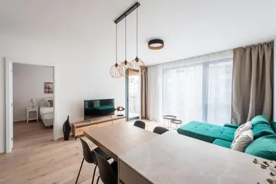 a living room with a green couch and a table at Jay Apartments in Prague