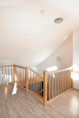 a staircase in a house with wooden railings at 150m² 4BR Duplex Near Metro & Prague Center in Prague