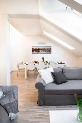 a living room with a couch and a table at 150m² 4BR Duplex Near Metro & Prague Center in Prague