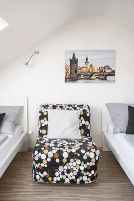 a living room with a couch in a room at 150m² 4BR Duplex Near Metro & Prague Center in Prague