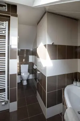 a bathroom with a tub and a toilet and a sink at 150m² 4BR Duplex Near Metro & Prague Center in Prague