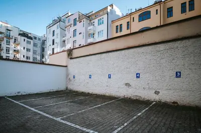 an empty parking lot with buildings in the background at 150m² 4BR Duplex Near Metro & Prague Center in Prague