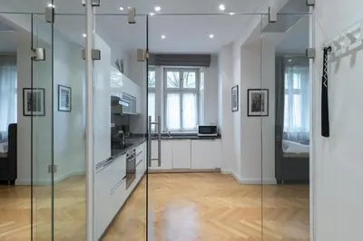 a kitchen with a glass partition in a room at Upscale apartments in prime location near all sights in Prague