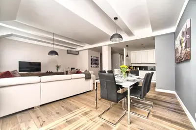 a living room with a white couch and a table at Exclusive 2 bedroom apartment Old Town - 2 baths, balcony and view - by Prague City Apartments in Prague