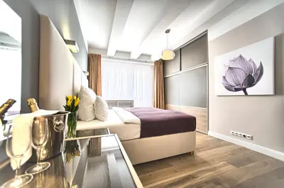 a hotel room with a bed and a table at Exclusive 2 bedroom apartment Old Town - 2 baths, balcony and view - by Prague City Apartments in Prague