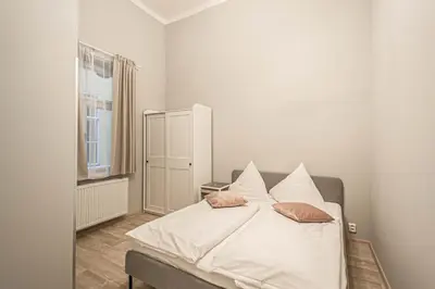 a bedroom with a bed with white sheets and pillows at Sightseeing apartment by Ruterra in Prague