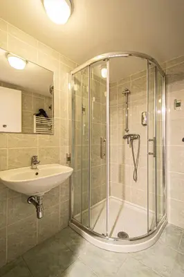 a bathroom with a shower and a sink at Sightseeing apartment by Ruterra in Prague