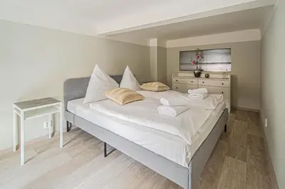 a bedroom with a large bed and a dresser at Sightseeing apartment by Ruterra in Prague