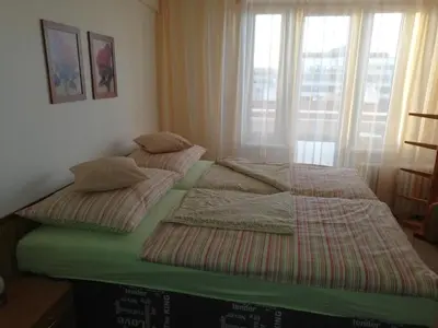 two twin beds in a room with a window at Terrace Studio Prague Center in Prague