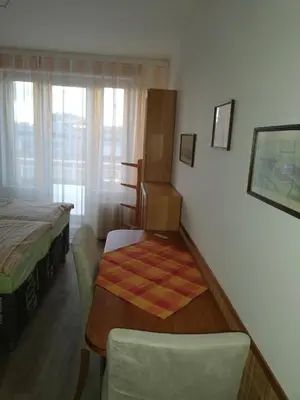 a bedroom with a bed and a table and a chair at Terrace Studio Prague Center in Prague