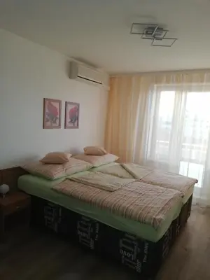 a bedroom with a large bed with a window at Terrace Studio Prague Center in Prague