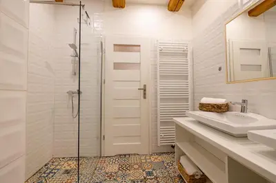 a white bathroom with a sink and a shower at Relax apartmán na Mlejnici in Nové Strašecí