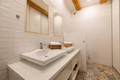 a white bathroom with two sinks and a mirror at Relax apartmán na Mlejnici in Nové Strašecí