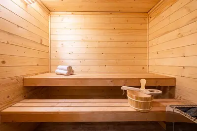 a wooden sauna with a bench and a bucket at Relax apartmán na Mlejnici in Nové Strašecí