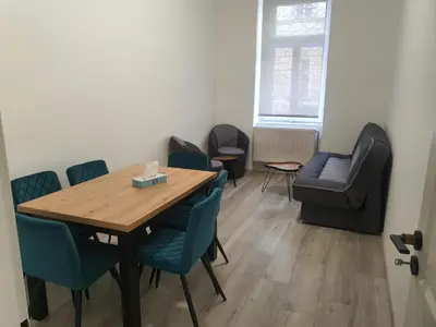 a dining room with a table and chairs and a couch at Hostel Comfort in Prague