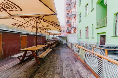 a row of tables with umbrellas on a street at Hostel Comfort in Prague