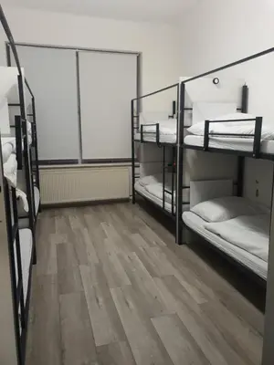 a room with three bunk beds and a wooden floor at Hostel Comfort in Prague