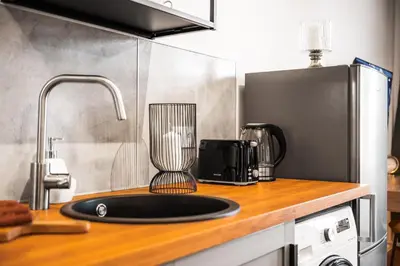 a kitchen counter with a sink and a blender at Majestic Square View Residence in Prague