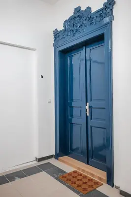 a blue door on the side of a building at Majestic Square View Residence in Prague