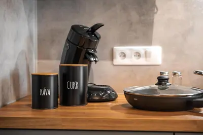 a coffee maker and two cups on a counter at Majestic Square View Residence in Prague
