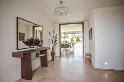 a living room with a large mirror and a table at Luxury villa near Prague with pool and tennis court in Čestlice
