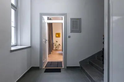 a hallway with a door leading into a room with stairs at Eclectic and design duplex in Prague in Prague