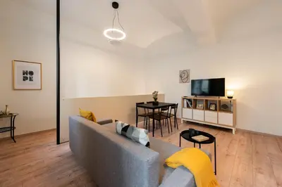 a living room with a couch and a tv at Eclectic and design duplex in Prague in Prague