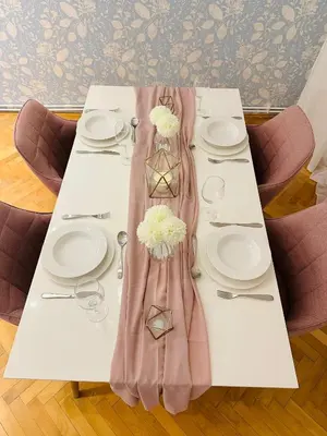 a table with white plates and a pink dress on it at Home away from home in Prague
