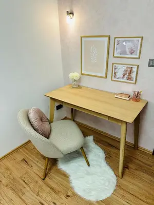 a desk and a chair in a room with a rug at Home away from home in Prague