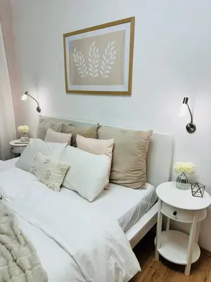 a white couch with pillows in a living room at Home away from home in Prague