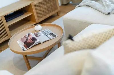 a coffee table with a magazine on it next to a couch at Rentero Cozy Wenceslas square 700m Apartment, Prague in Prague