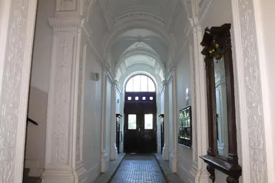 a hallway with a black door in a building at Royal Prague Apartment Celakovskeho Sady in Prague