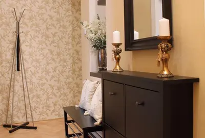 a room with a dresser with two candles and a mirror at Royal Prague Apartment Celakovskeho Sady in Prague