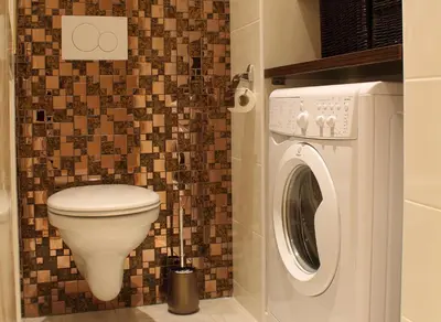 a bathroom with a toilet and a washing machine at Royal Prague Apartment Celakovskeho Sady in Prague