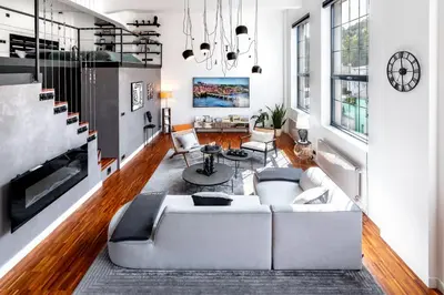 a living room with a white couch and a table at The Factory Loft Prague in Prague