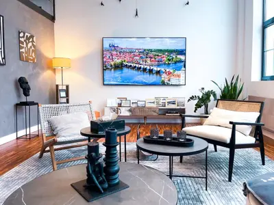 a dining room with a table and a kitchen at The Factory Loft Prague in Prague